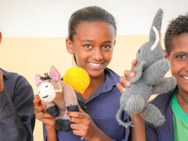 Three Children with knitted crocheted animals Ethiopia