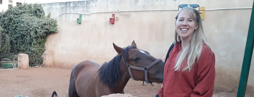woman standing with a donkey