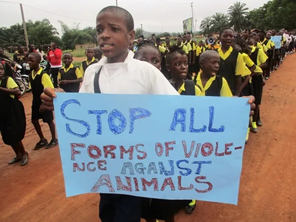 Group of children and a boy holding poster with against violence slogan