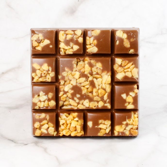 Milk chocolate square with pieces of honeycomb