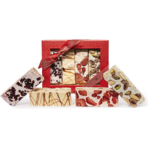 Image of a red gift box of assorted nougat with loose nougat