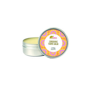 Image of an open tin with a colourful orange pattern containing citrus hand balm