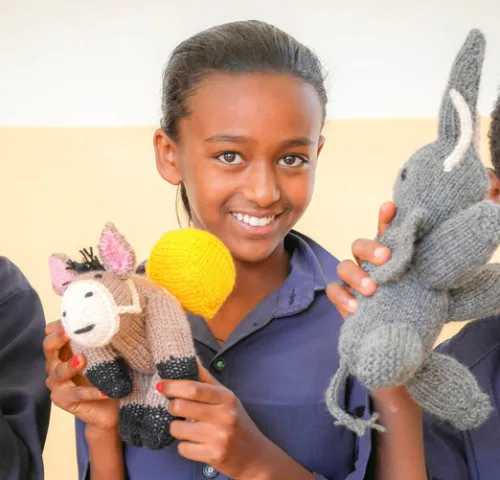 Three Children with knitted crocheted animals Ethiopia