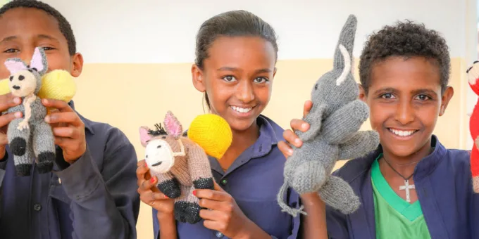 Three Children with knitted crocheted animals Ethiopia