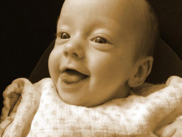 Sepia photo of smiling baby