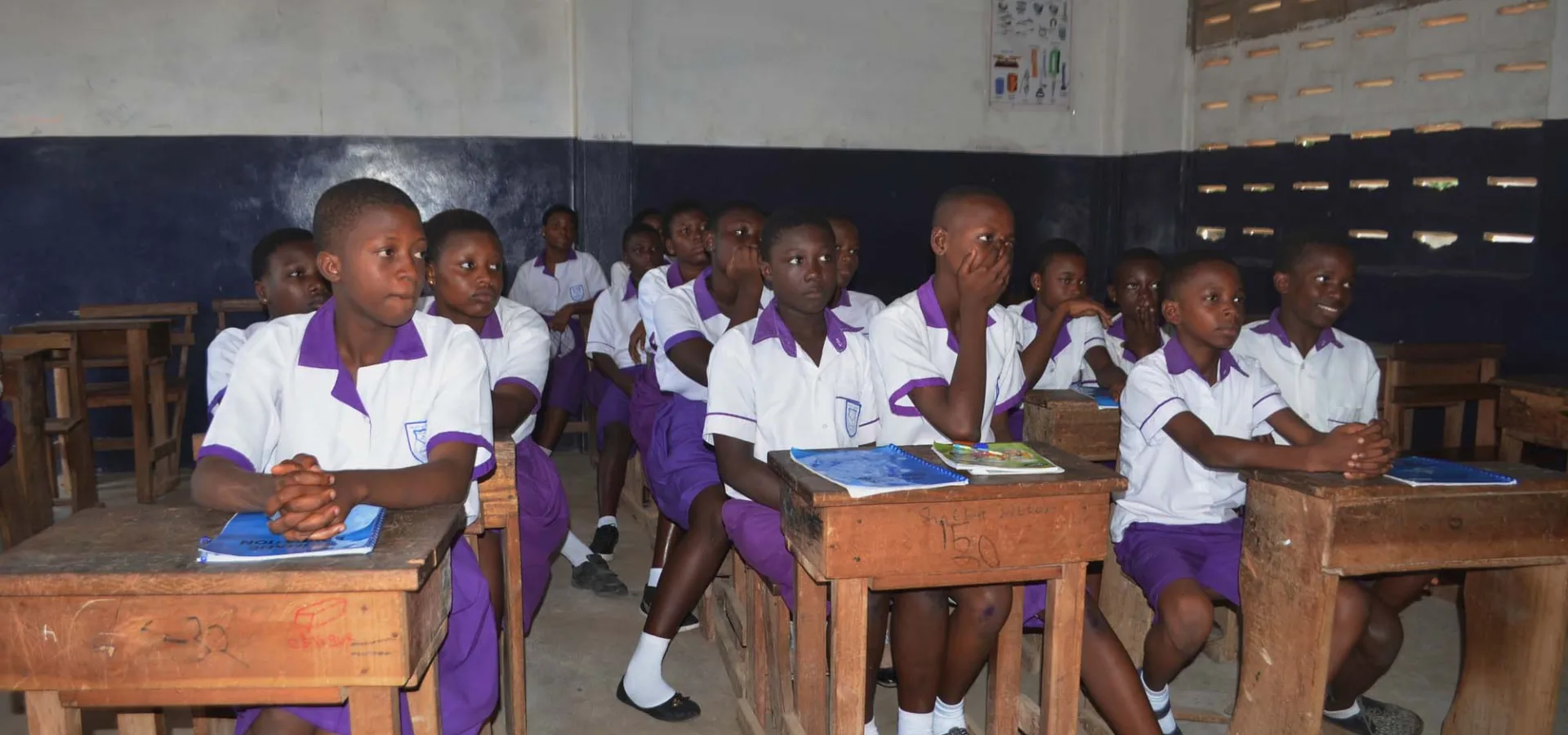 Schoolgirls sitting at desks in classroom