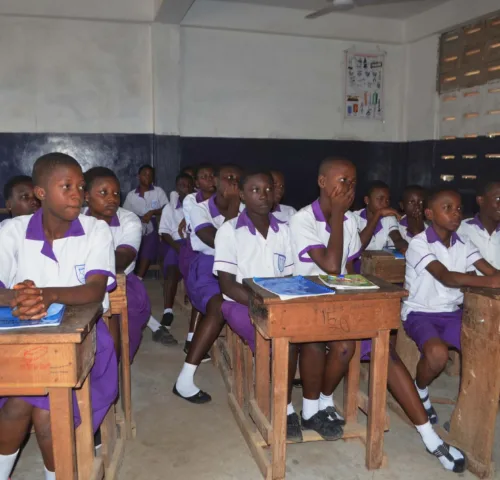 Schoolgirls sitting at desks in classroom
