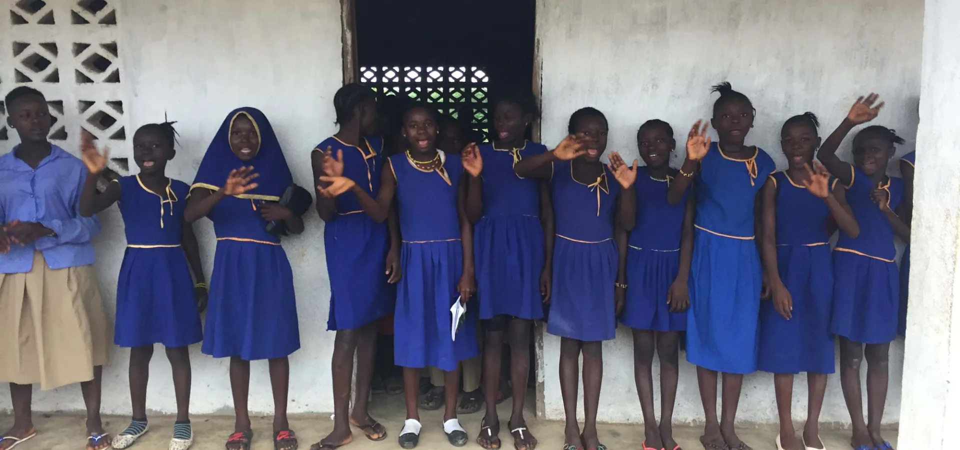 Schoolgirls in a line waving