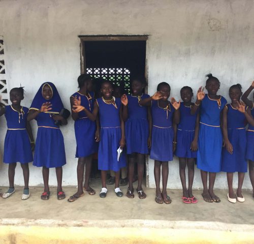 Schoolgirls in a line waving