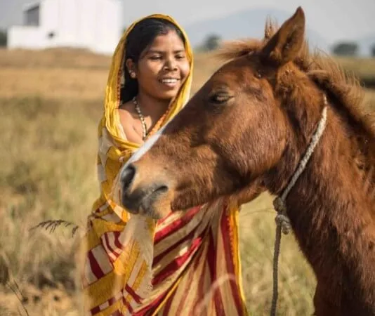 gita and her owner in a field