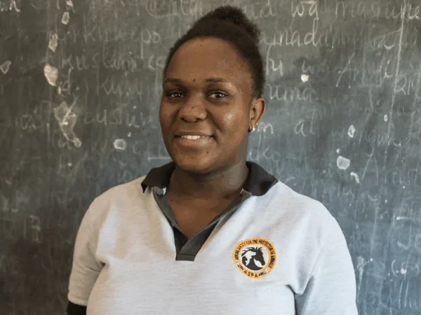 Diana stands in front of the blackboard