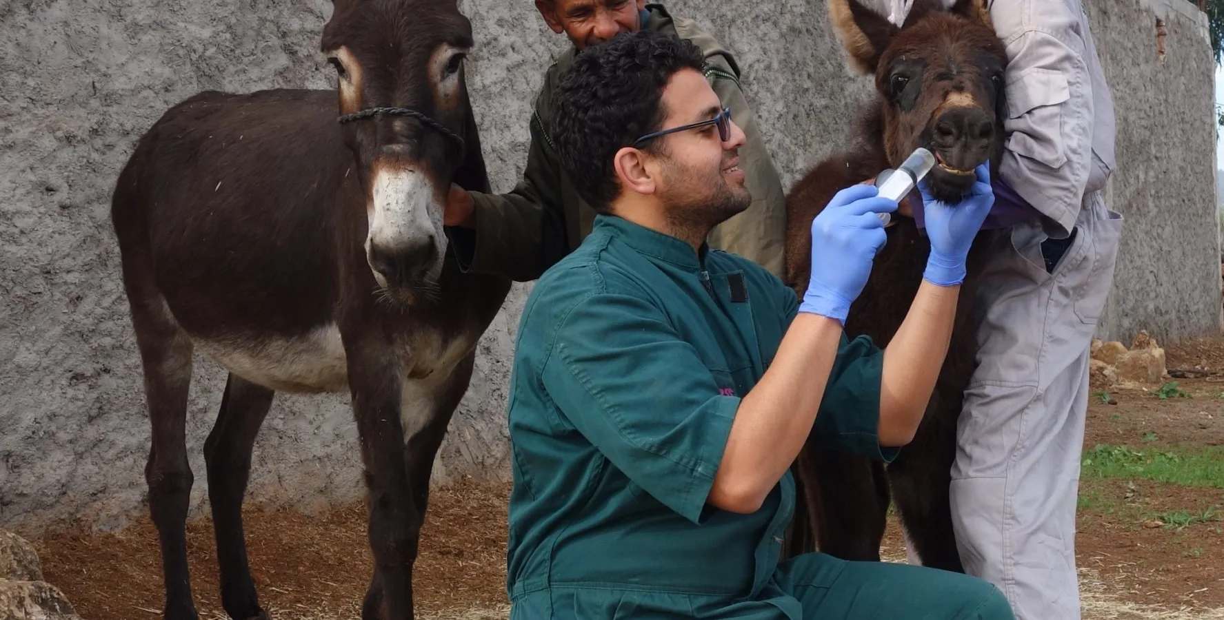 Najia stands with her mother while receiving follow up care at home outside of Chemaia