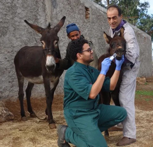 Najia stands with her mother while receiving follow up care at home outside of Chemaia