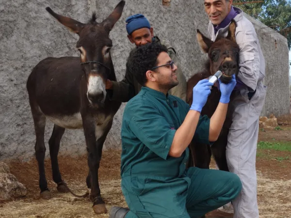 Najia stands with her mother while receiving follow up care at home outside of Chemaia