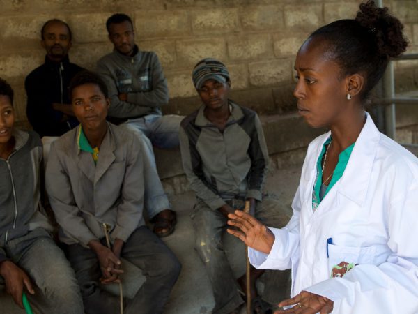 A SPANA Ethiopia vet talks to animal owners during a community training day