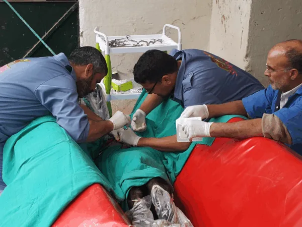 Three SPANA Vets operating on a mule