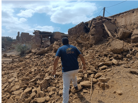 A SPANA vet walks through the ruins of a village destroyed by an earthquake in Morocco