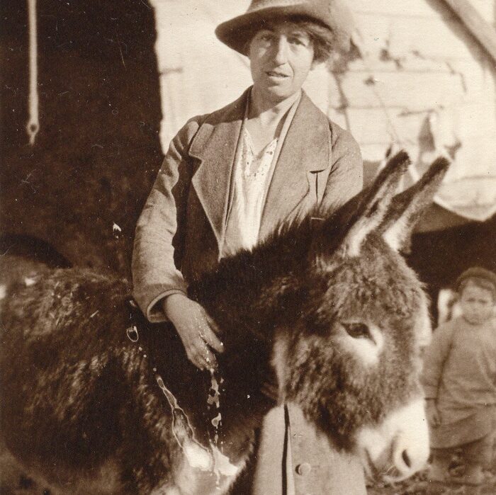 sepia tone photo of Kate Hosali, founder of SPANA, and a donkey