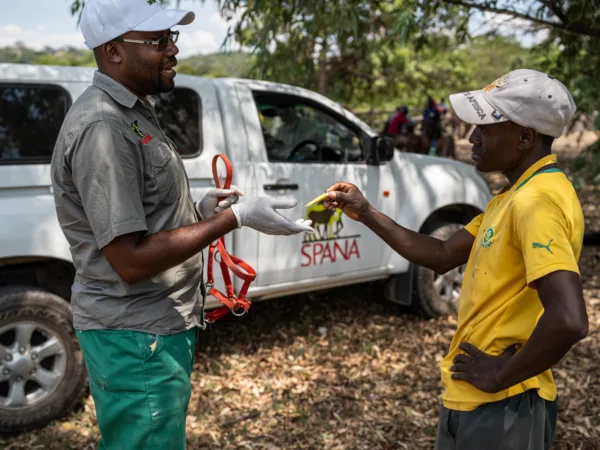 An owner receives medication for his working donkey at a SPANA mobile clinic in Zimbabwe