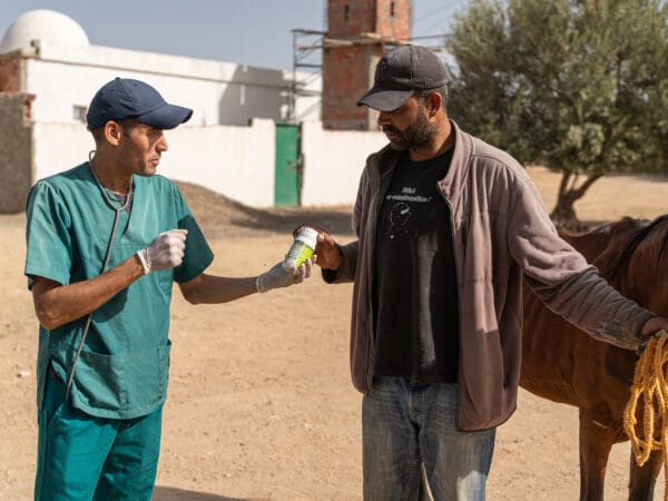 An owner receives medication for his working horse at a SPANA mobile clinic in Tunisia