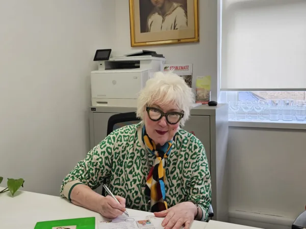 Comedian and actress Jenny Eclair signs a certificate of authenticity for her donkey painting which is raffling to raise funds for working animals