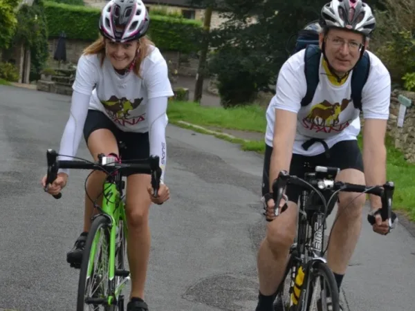Anna Marie and her dad cycling in SPANA tshirts